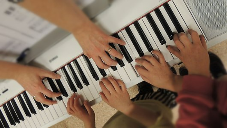 Händer som spelar på ett piano